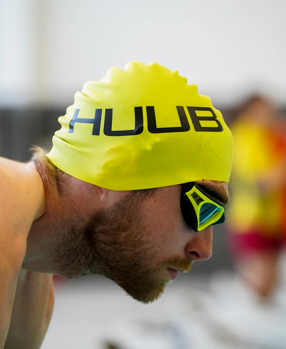 Bright orange HUUB silicone swim cap with smooth, stretchy material ideal for competitive swimming or training.